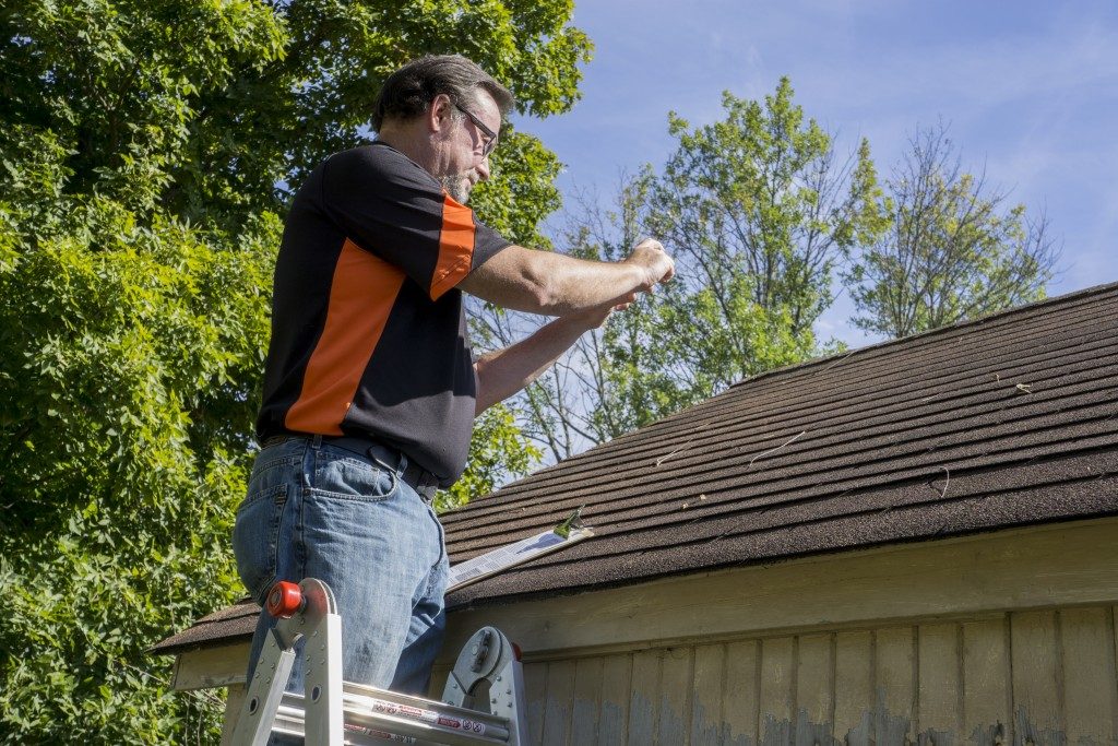 Homeowner picturing the hole in his roof