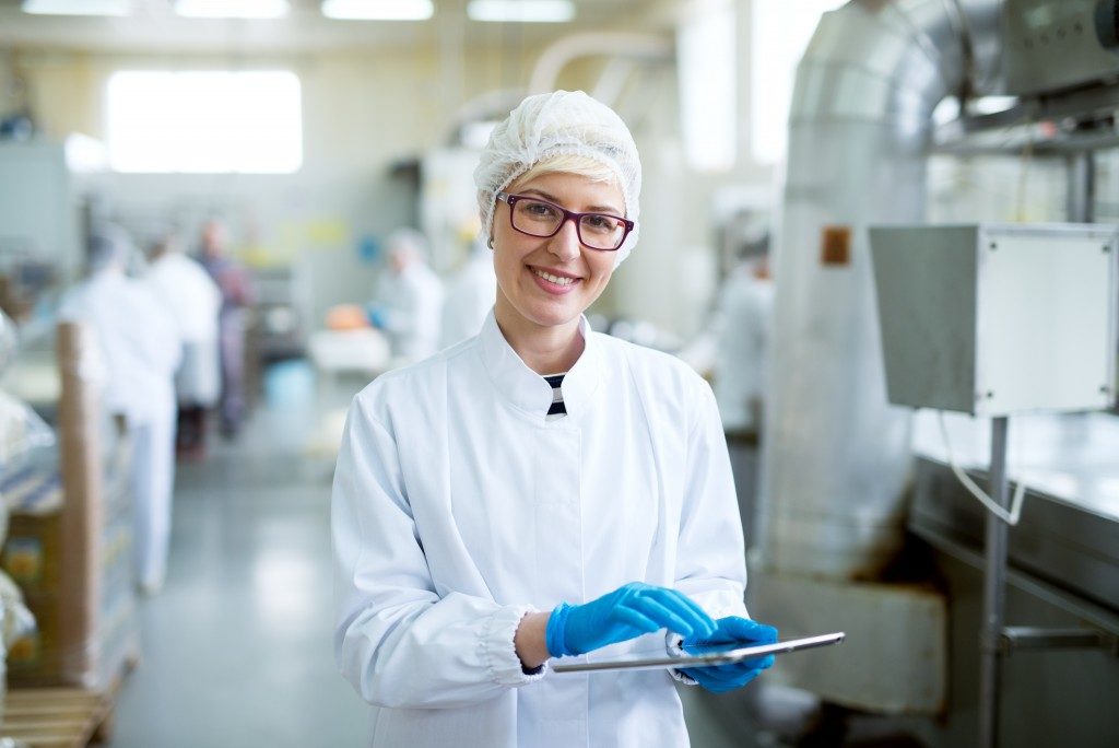 Female worker in sterile clothes