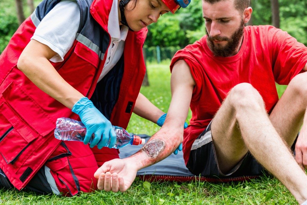 paramedic doing first aid on a man