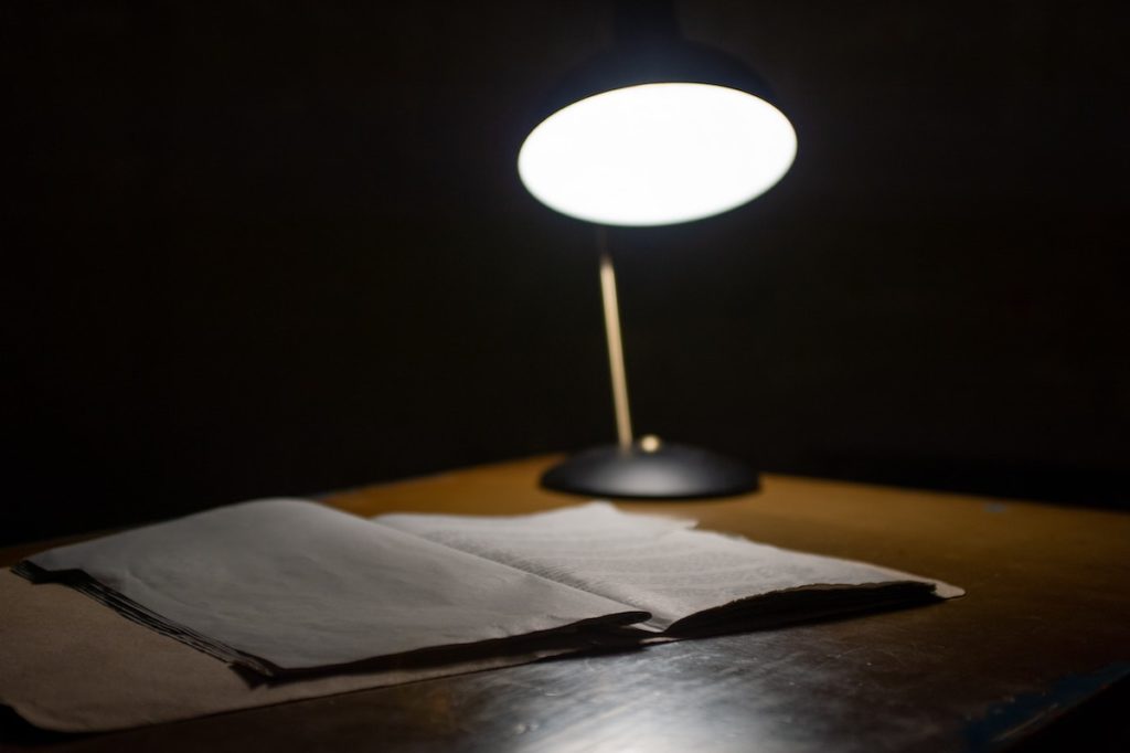 light from lamp shining on notebook