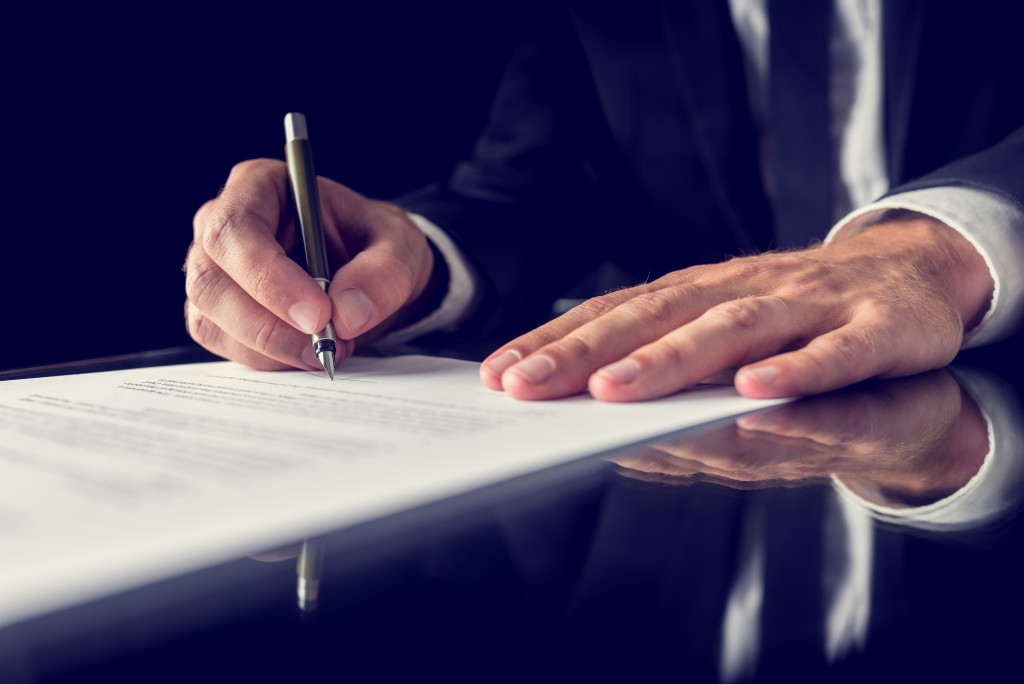A person signing business contract
