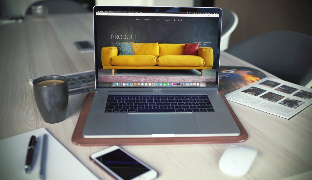 laptop showing homepage of furniture website