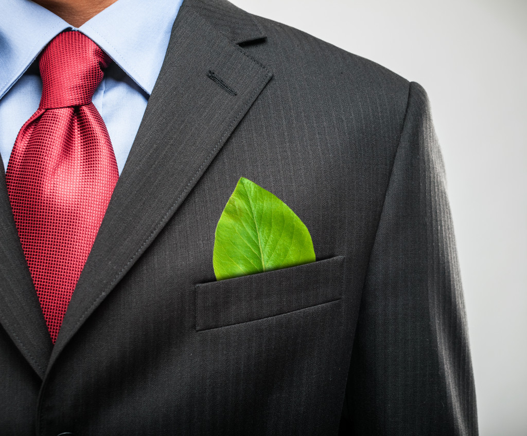 businessman with green leaf in pocket concept of sustainable business